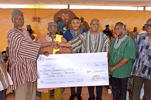 Kwamina-Asomaning-Chief-Executive-Officer-Stanbic-Bank-Ghana-presenting-the-cheque-to-representative.webp