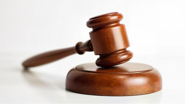 a-wooden-judge-gavel-rests-on-a-matching-sound-block-isolated-on-a-white-background-suitable-for-leg.jpeg