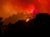 Fast-moving Canada wildfire doubles in size forcing thousands to flee homes