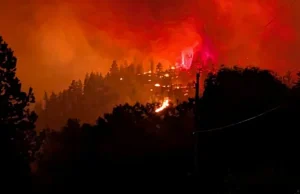 Fast-moving Canada wildfire doubles in size forcing thousands to flee homes